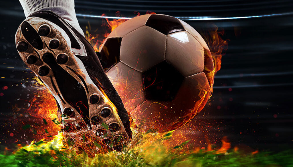 Powerful kick of a soccer player with fiery ball